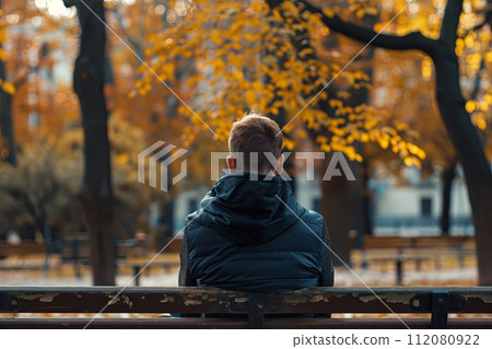 Man Sitting on Bench in Park 112080922
