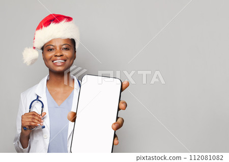 Medical worker Santa showing smartphone with blank empty white screen display for new Application  112081082