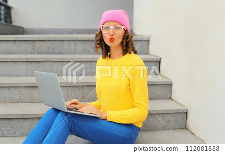 Portrait of modern cool young woman with laptop in the city 112081888
