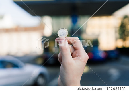 Euro coin and refueling of a car at a gas station in city, expensive fuel oil 112083131