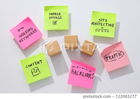 Notes and three wooden cubes on white background, top view 112083277