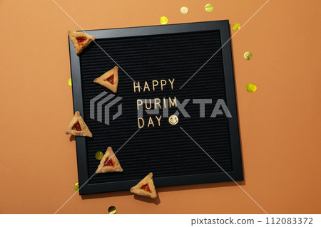 A mask with traditional cookies for the day of Purim. A mask with traditional cookies for the day of Purim. 112083372
