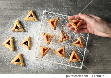 A mask with traditional cookies for the day of Purim. 112083460
