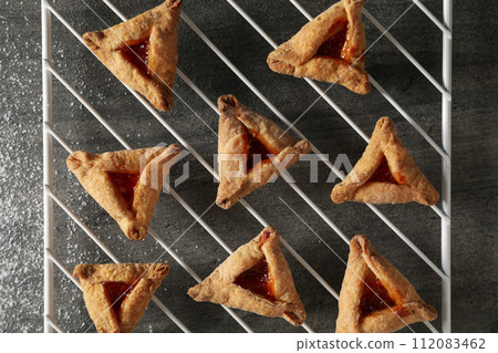A mask with traditional cookies for the day of Purim. 112083462