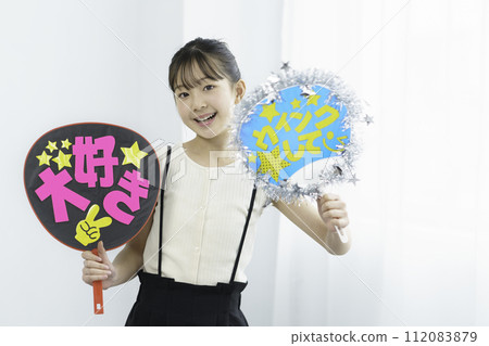 Oshikatsu: A girl waving a fan to support the Oshikatsu 112083879