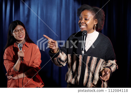 Young comedian pointing at audience 112084118