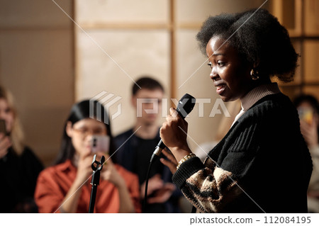 Woman performing in front of audience 112084195