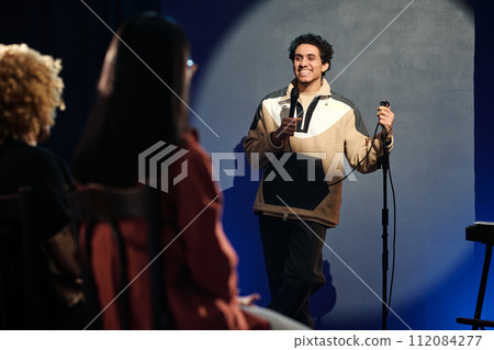 Young male comedian talking to audience Young male comedian talking to audience 112084277