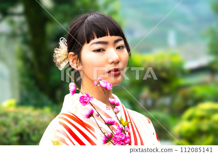A woman in Japanese clothes standing in the garden A woman in Japanese clothes standing in the garden 112085141