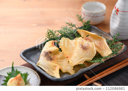 Grilled sea bream fin and sake Grilled sea bream fin and sake 112086981