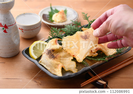 Grilled sea bream fin and sake Grilled sea bream fin and sake 112086991