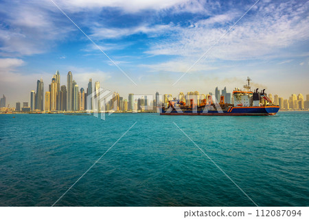 Cargo ship sailing to the Dubai marina port 112087094