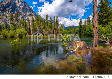 Merced River flowing through Yosemite National Park in California, USA 112087103