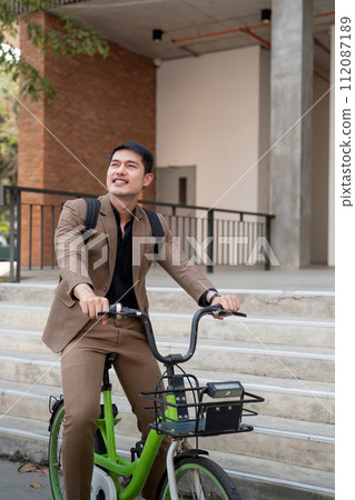 The businessman eco friendly transportation, cycling through the city avenues to go to work. sustainable lifestyle concept 112087189