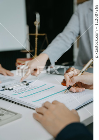 Legal counsel presents to the client a signed contract with legal law. justice and lawyer concept in office. 112087268
