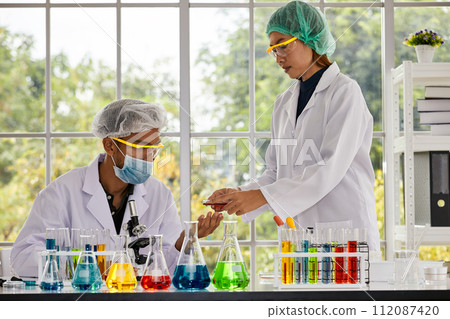 Two Scientists Combine Efforts with Test Tube and Tablet Analysis; Collaborative Discovery Two Scientists Combine Efforts with Test Tube and Tablet Analysis; Collaborative Discovery 112087420