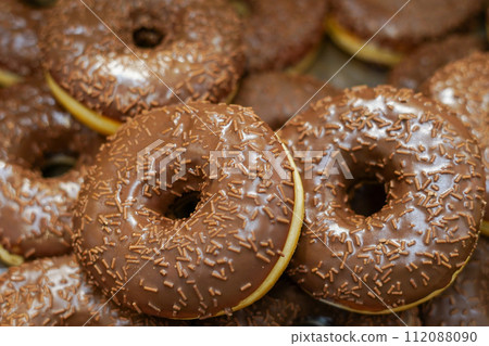 assorted donuts with chocolate frosted and glazed in the grocery store 112088090