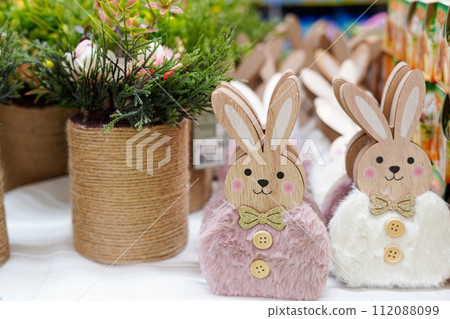 Easter decorations in the store bunnies and flowers in the pots 112088099
