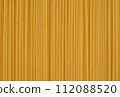 Parallel lines of uncooked spaghetti create a linear pattern on a yellow background, perfect for culinary and food themes. 112088520