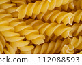 Close-Up of Uncooked Fusilli Pasta Texture 112088593