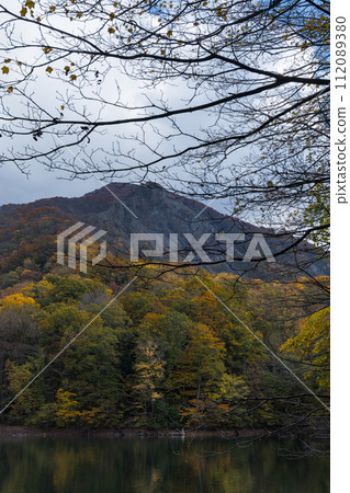 Japan: A large collapse of Mt. Kozureyama and autumn leaves from Kotoba Pond in Juniko, a group of lakes and marshes located in the western part of the Shirakami Mountains in Fukaura Town, Nishitsugaru District, Aomori Prefecture. Japan: A large collapse of Mt. Kozureyama and autumn leaves from Kotoba Pond in Juniko, a group of lakes and marshes located in the western part of the Shirakami Mountains in Fukaura Town, Nishitsugaru District, Aomori Prefecture. 112089380