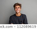 Smiling young brown-haired man on gray background 112089619