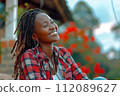 African woman with dreadlocks in her hair smiling and happy 112089627