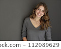 beautiful and smiling young woman with long brown hair 112089629