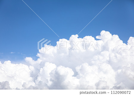 Huge white cumulus cloud against blue sky Huge white cumulus cloud against blue sky 112090072