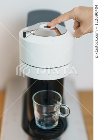 hand making Espresso Coffee by Coffee Maker Machine on wood table bar. Daily beverage drink at Home, Apartment and Office concept hand making Espresso Coffee by Coffee Maker Machine on wood table bar. Daily beverage drink at Home, Apartment and Office concept 112090404