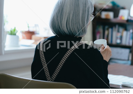 Rear view of a senior woman living alone Rear view of a senior woman living alone 112090762