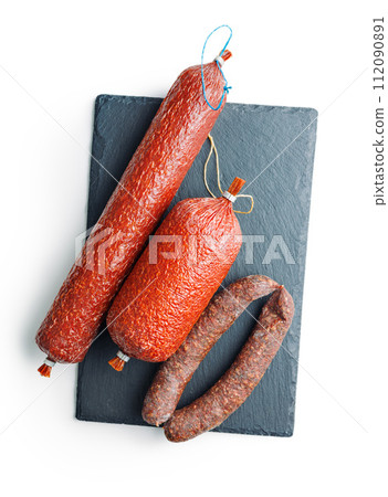 Smoked salami sausages isolated on white background. Smoked salami sausages isolated on white background. 112090891