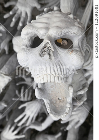 Skull from hell at Wat Rong Khun in Chiang Rai 112091681