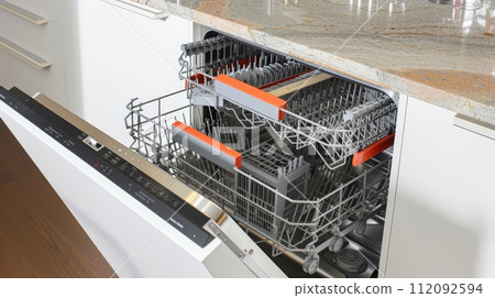 Close-Up of Open Dishwasher in a Sleek Modern Kitchen 112092594