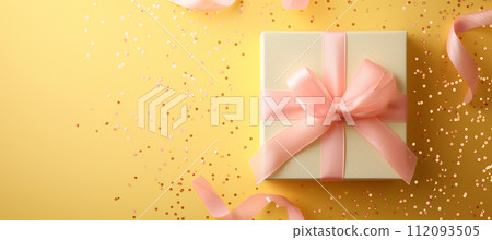 Elegant gift box in pastel color with pink ribbon on sparkling yellow background Elegant gift box in pastel color with pink ribbon on sparkling yellow background 112093505