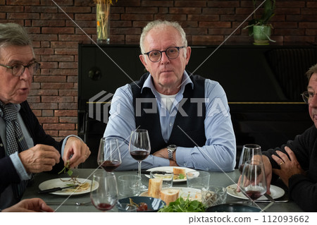 Thoughtful Senior Gentleman at a Dinner Party 112093662