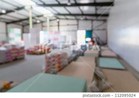 Hardware construction supermarket aisle and rows with bags of cement and stacks of drywall. 112095024
