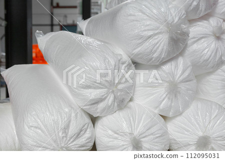 A bunch of bags of loose granular foam in a commercial warehouse. A bunch of bags of loose granular foam in a commercial warehouse. 112095031