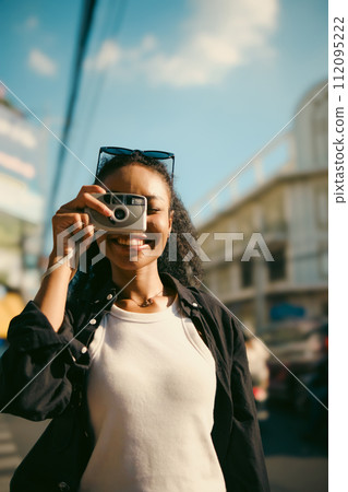 Asian woman enjoy travel in  downtown district 112095222