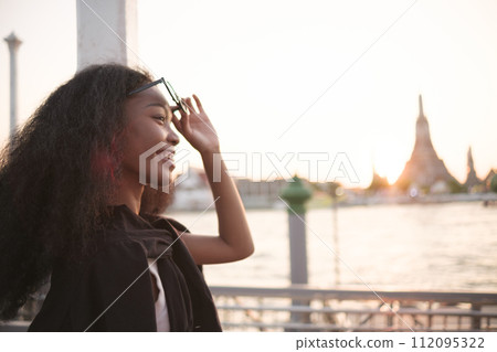 Asian woman enjoy travel in  downtown district 112095322