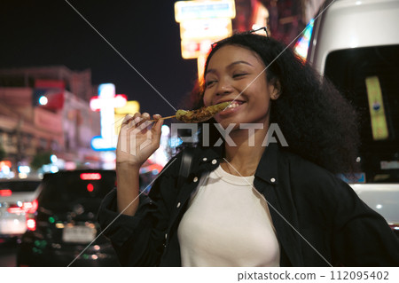 Asian woman enjoy travel in  downtown district 112095402