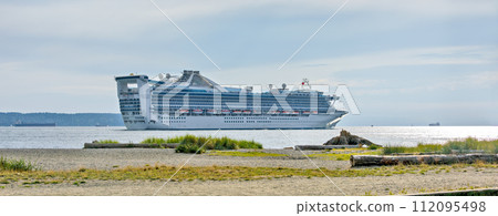 White ocean cruise liner passing by Burrard inlet in Vancouver, Canada 112095498