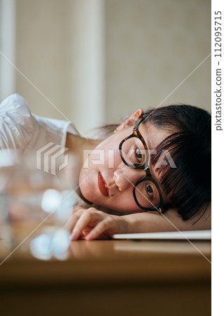young woman staring at a glass young woman staring at a glass 112095715