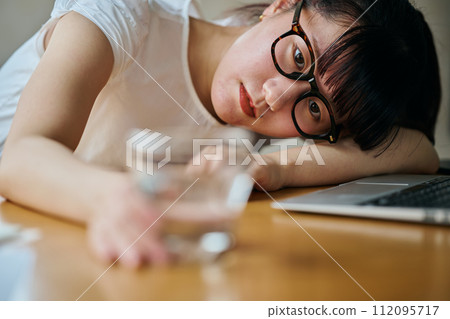 young woman staring at a glass young woman staring at a glass 112095717