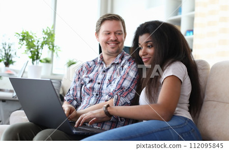 Spouse resting on couch together Spouse resting on couch together 112095845
