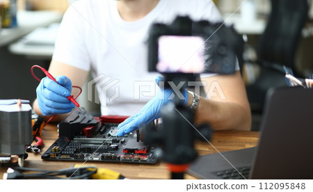 Guy mechanic and disassembled construction Guy mechanic and disassembled construction 112095848