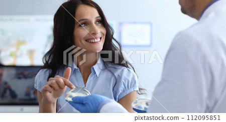 Woman touching implants 112095851
