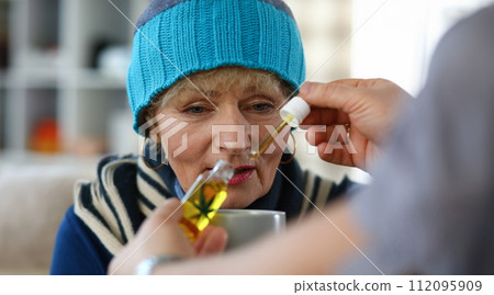 Elderly woman taking medicine Elderly woman taking medicine 112095909