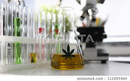 In chemical laboratory on table is flask hemp oil In chemical laboratory on table is flask hemp oil 112095984