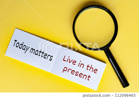 Today matters text on white notepad with magnifying glasses on yellow cover background Today matters text on white notepad with magnifying glasses on yellow cover background 112096465